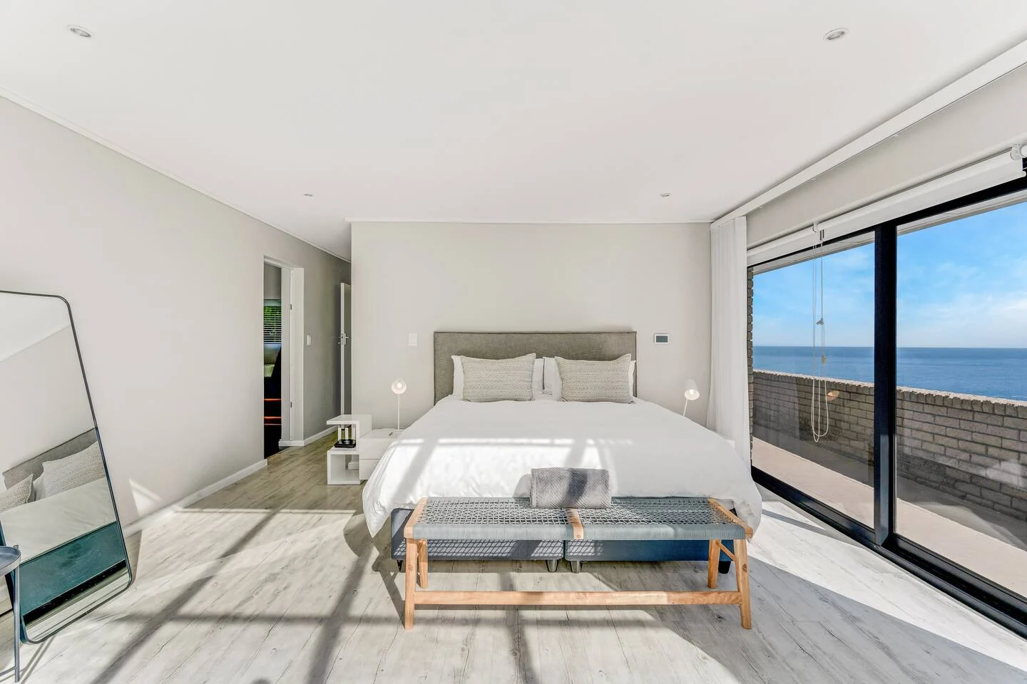 Double bed facing broad sliding doors and the Atlantic horizon