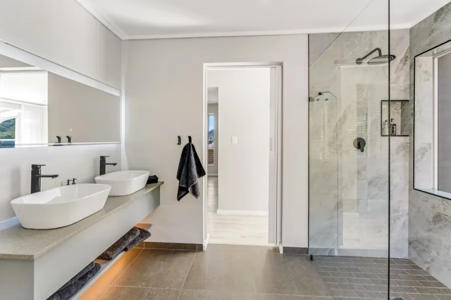 Contemporary bathroom with twin basins and a walk-in shower