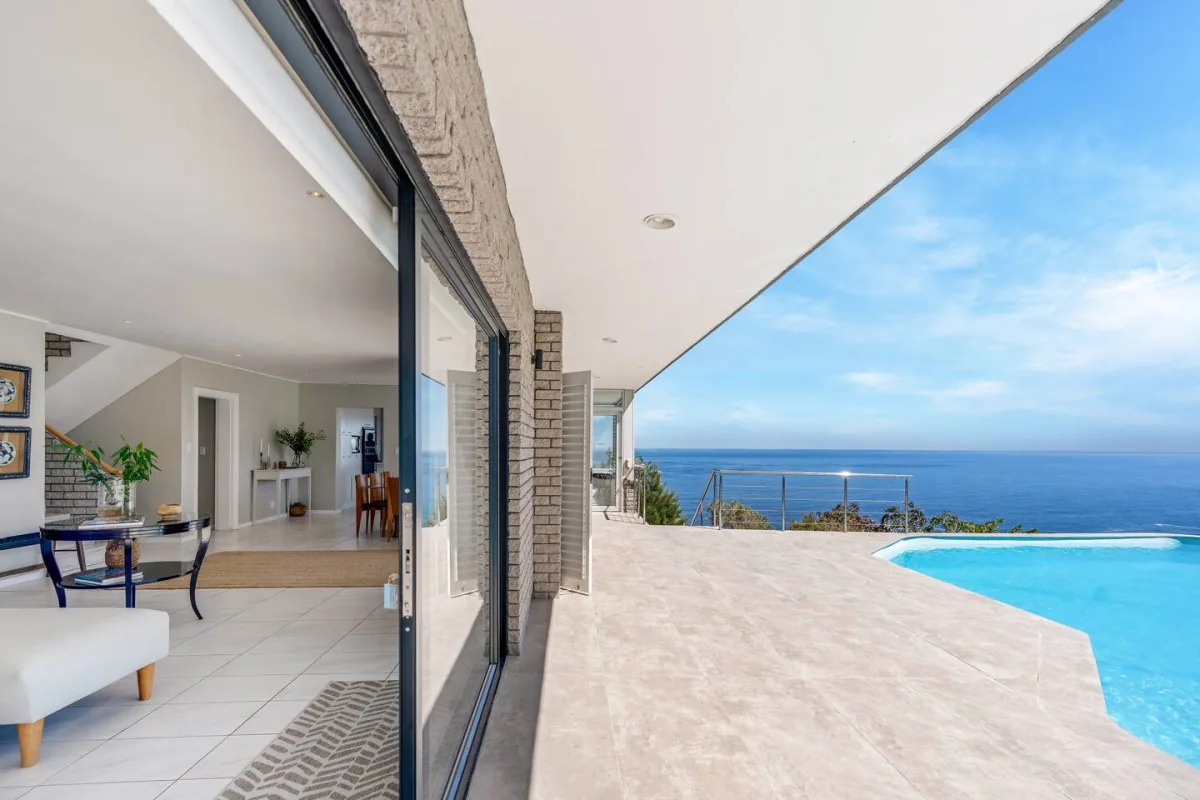Covered terrace opening toward the pool and Atlantic